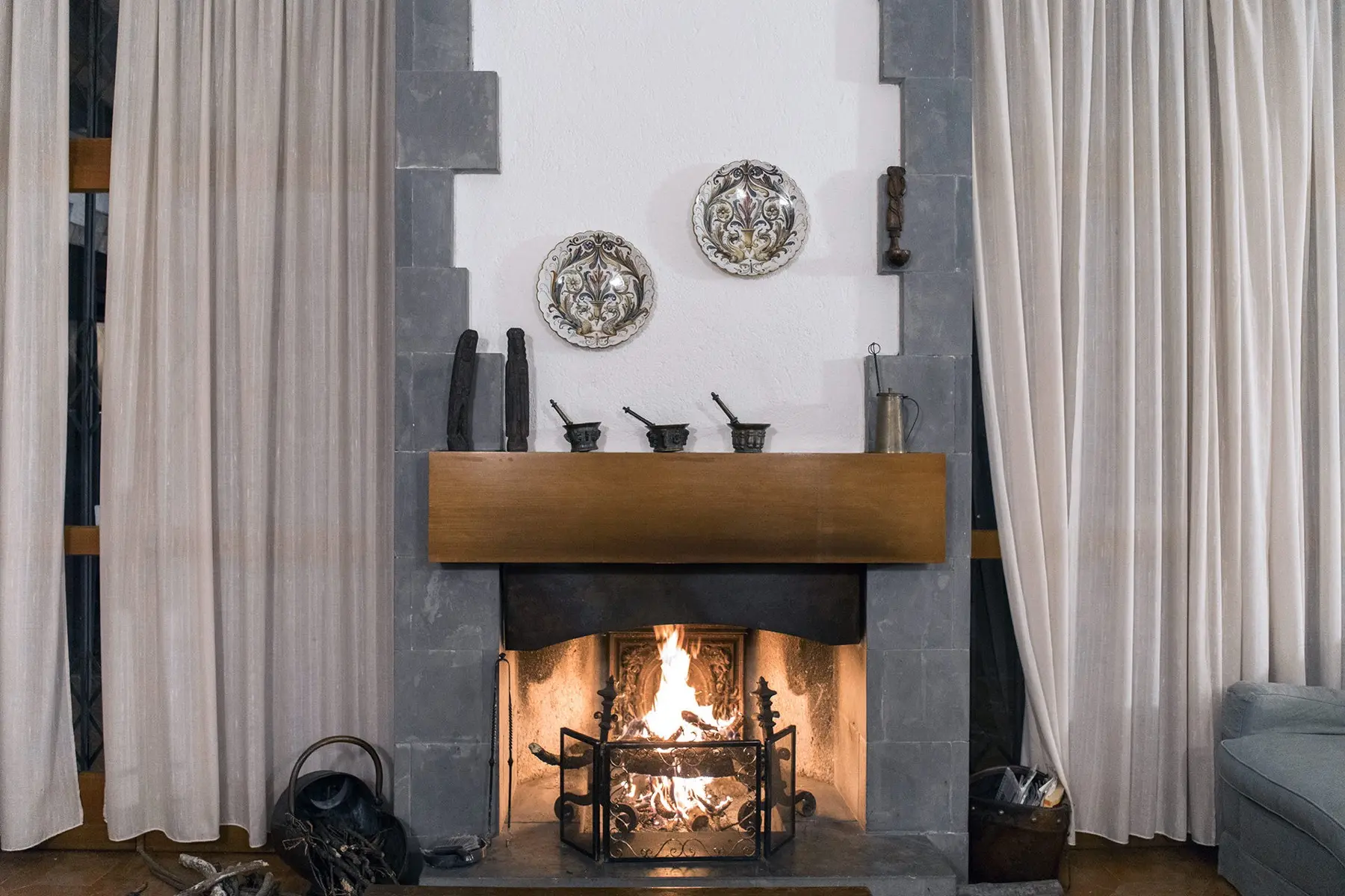 The fireplace lit in the living room